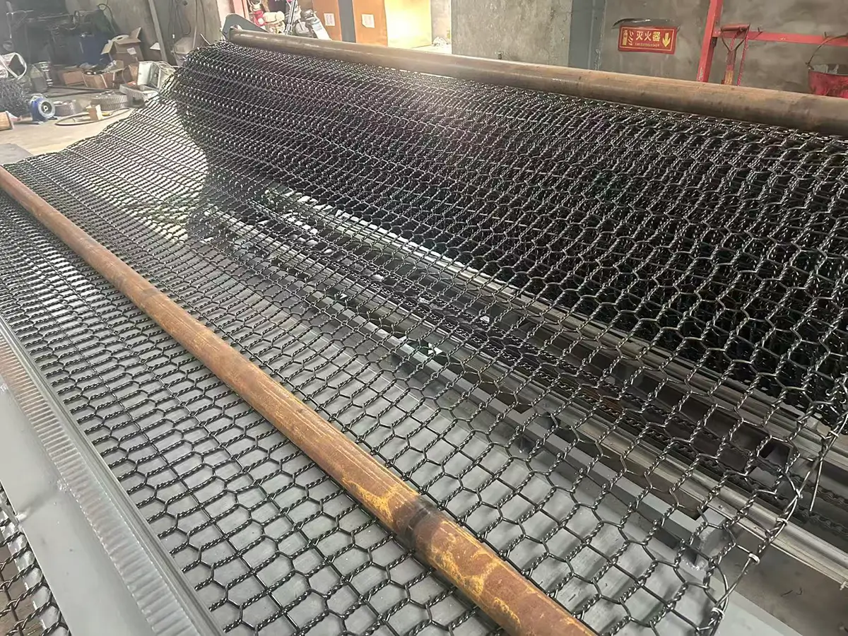Completed hexagonal mesh being automatically wound into full rolls by the take-up unit for dispatch or downstream processing
