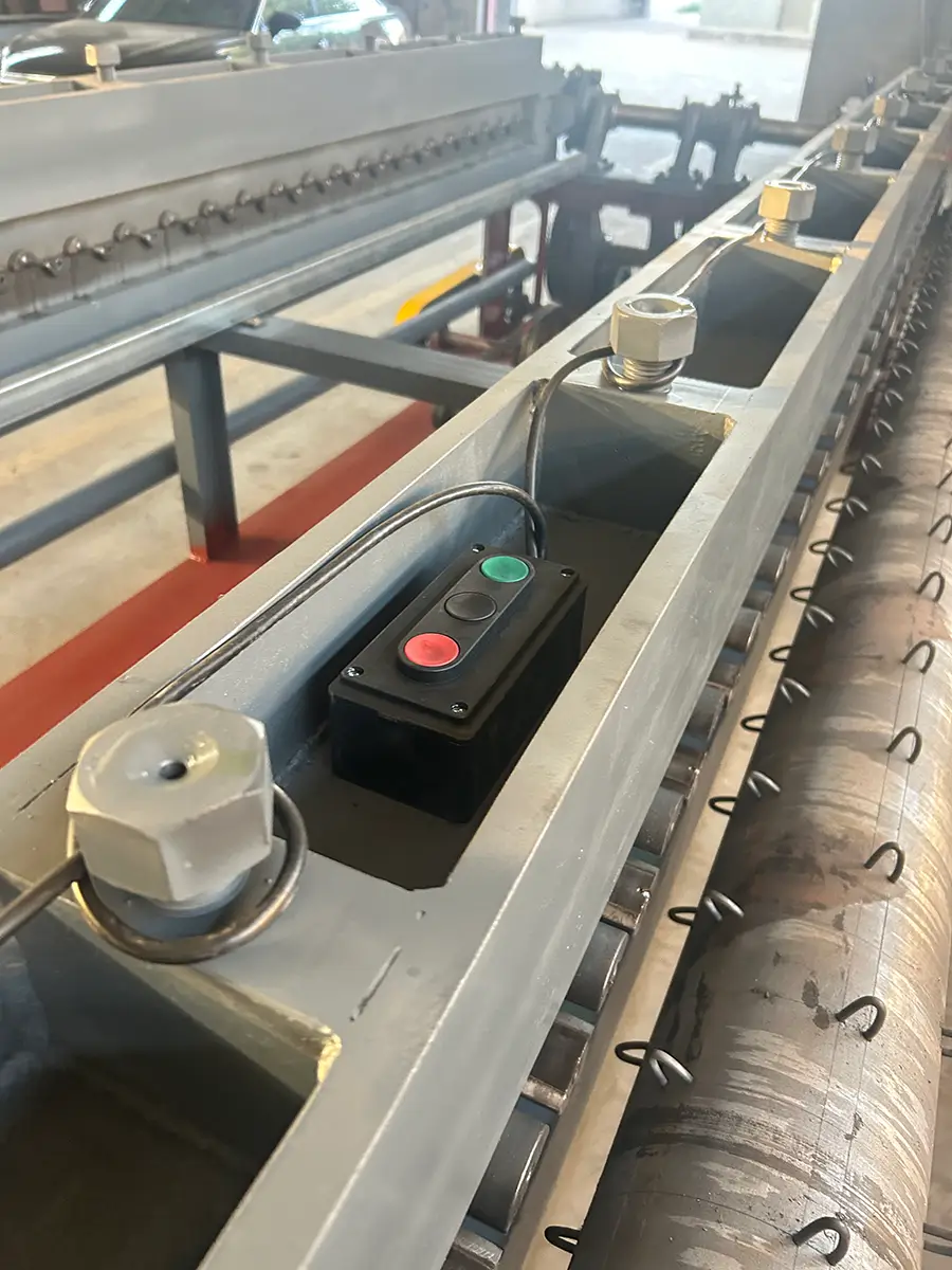 Detail view of the horizontal gabion mesh machine showing the control panel with start, pause, and jog buttons alongside the oil lubrication system for the core weaving components.