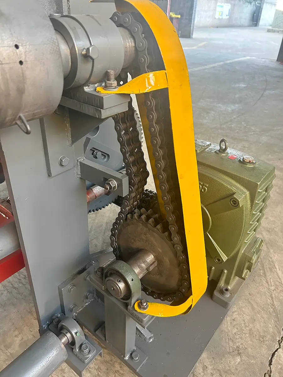 Detail view of the horizontal gabion mesh machine drive system, showing a 1:30 ratio gearbox driving the barb shaft via sprocket chain transmission to roll out the finished gabion mesh.