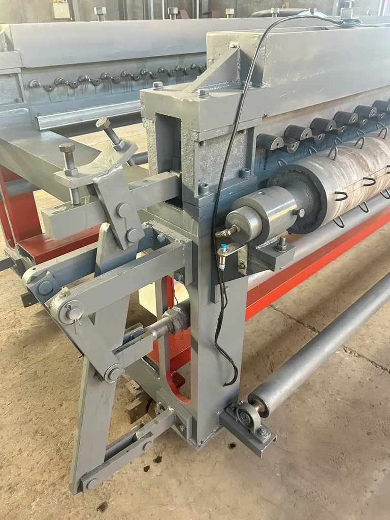 Close-up view of the output section on a horizontal gabion mesh machine, highlighting the counting sensor, guide mechanism, and related drive components with their mounting positions and layout.