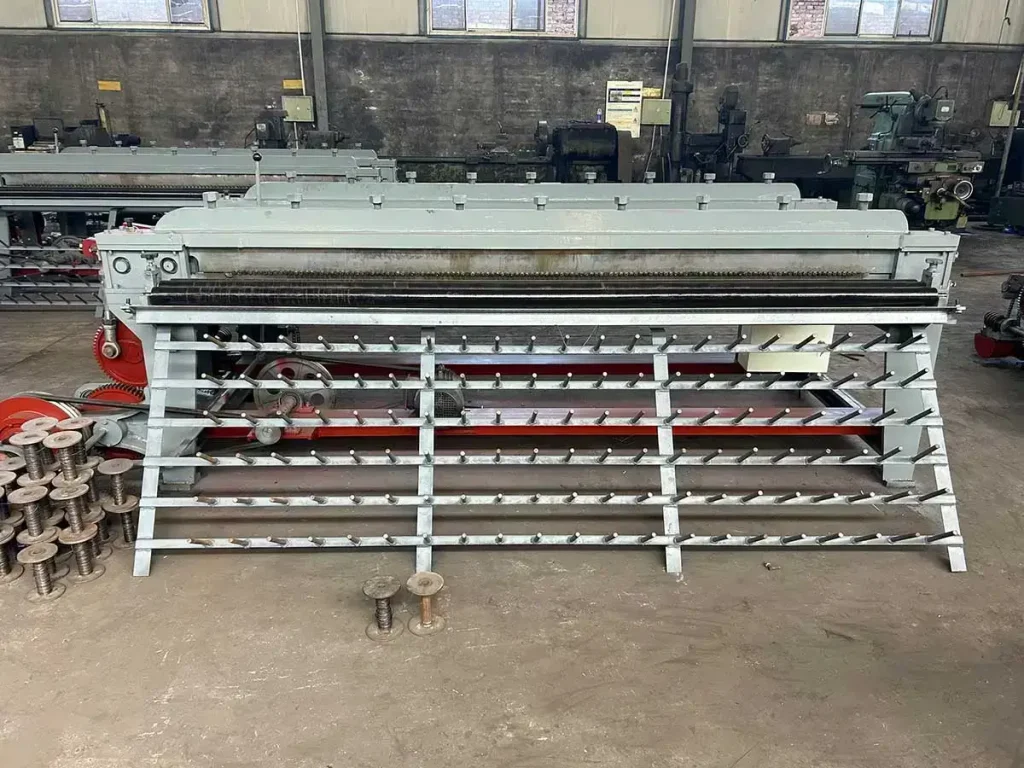 Small hexagonal wire mesh machine rear view, wire feeding peg rack