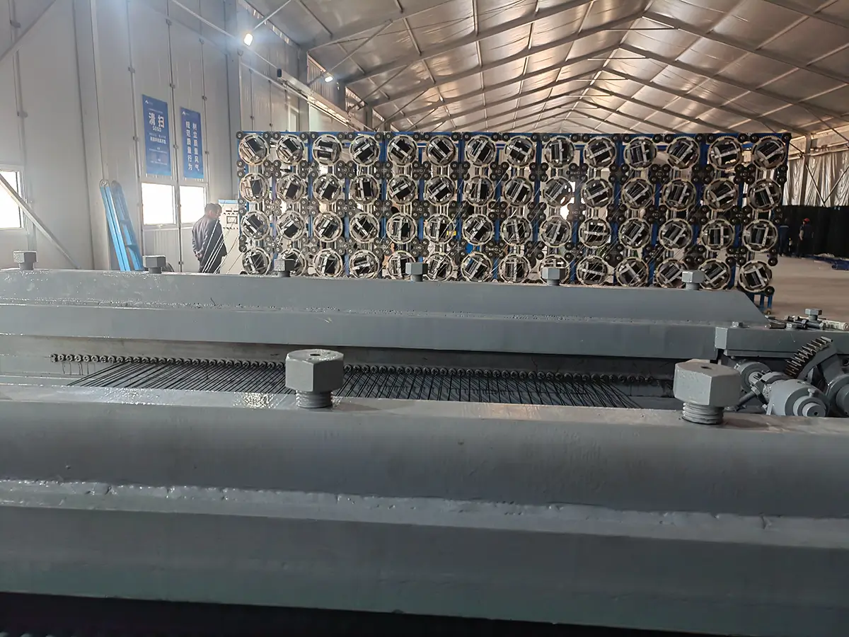 PET polyester monofilament being fed at controlled tension from a payoff rack into the weaving head