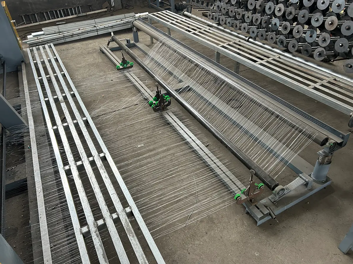 Wire guide plate directing multiple wires from the reel stand into the automatic hexagonal wire mesh machine for aligned and tension-controlled feeding